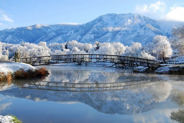 Reflection in the water of the landscape in winter bright weather