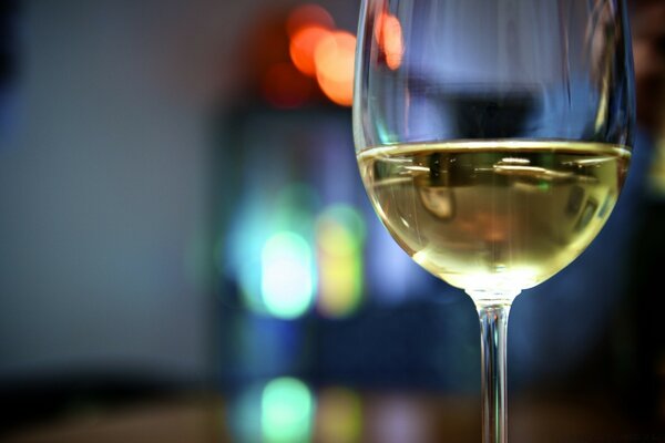 A glass of white wine on a blurry background