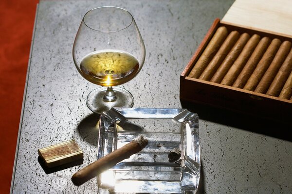 Close-up of cognac glass and cigars