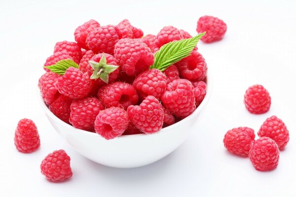 A full bowl of raspberries on a white background