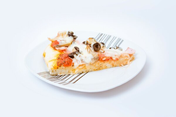 A slice of pizza with chicken and mushrooms on a white plate with black stripes