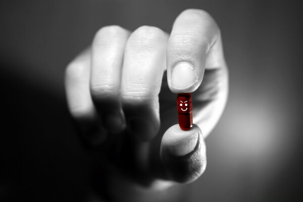 Red Evil pill in hand