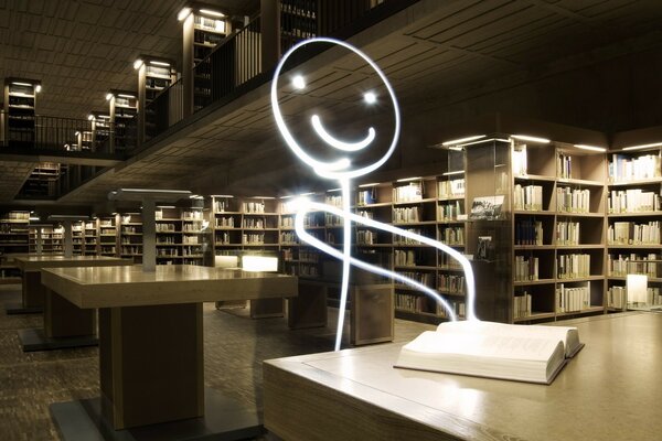 A glowing painted man reads a book