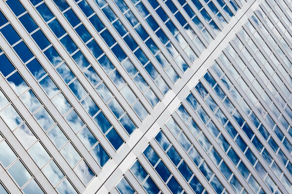 A picturesque reflection of the sky in the windows of a multi-storey building