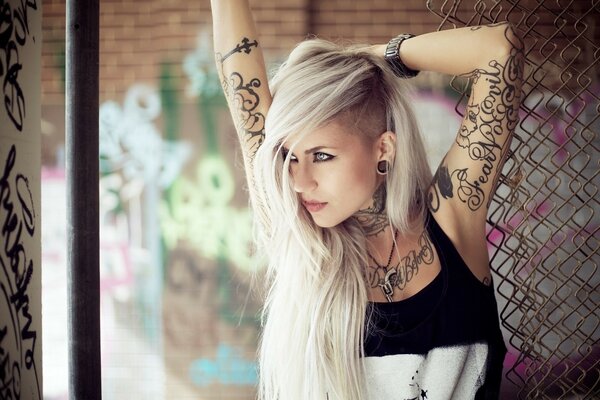 Beautiful tattooed blonde with long hair