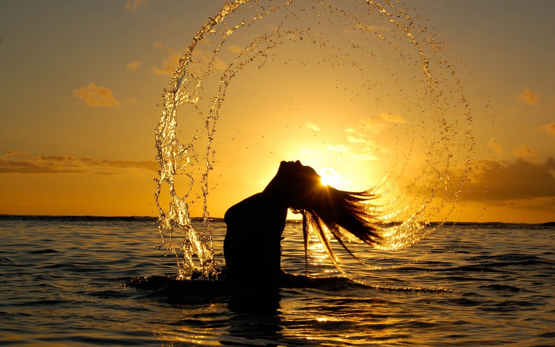 in swimsuits sunset water dawn sea sun evening beach ocean reflection dusk silhouette backlit wave sky