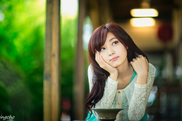 The girl looks up thoughtfully on the terrace