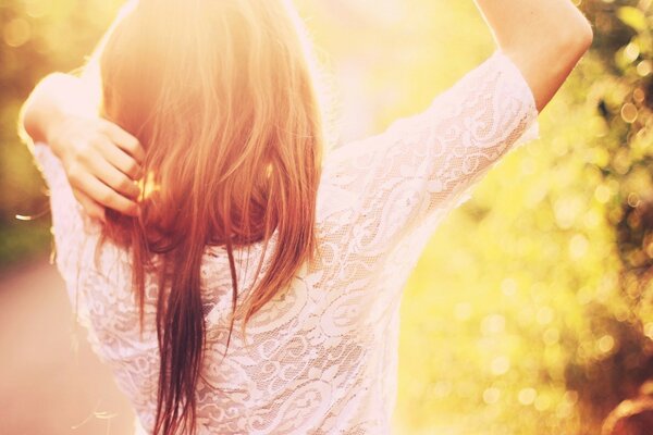 A girl enjoys the sunlight in nature