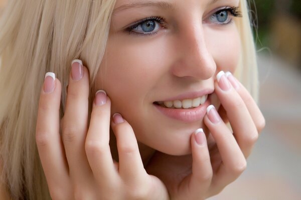 Chica rubia con manicura francesa