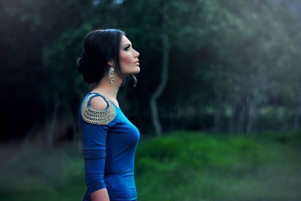 A girl in a blue dress in nature