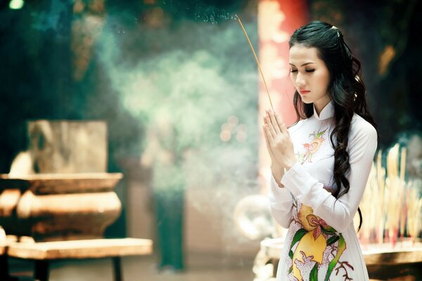 A girl with scented candles conducting a retual