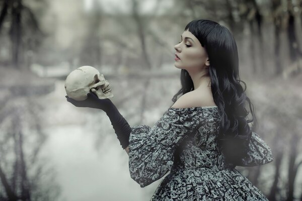 Gothic girl holding a skull in her hand