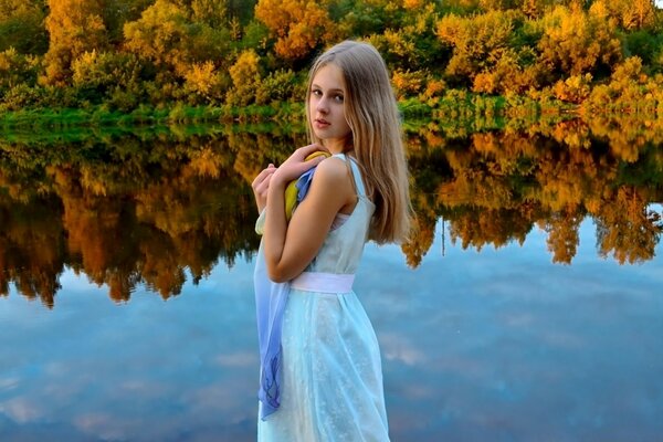 A girl on the background of an autumn landscape