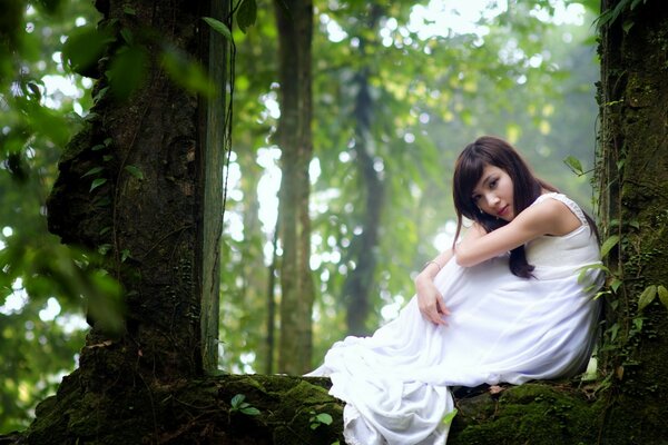 A girl in a white shirt in the forest