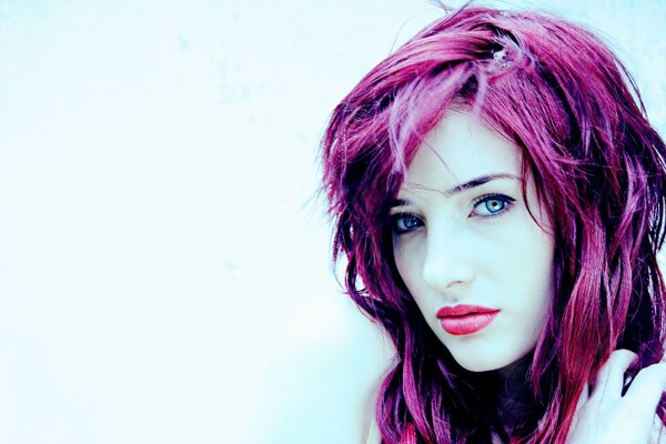 A woman with purple hair on a blue background