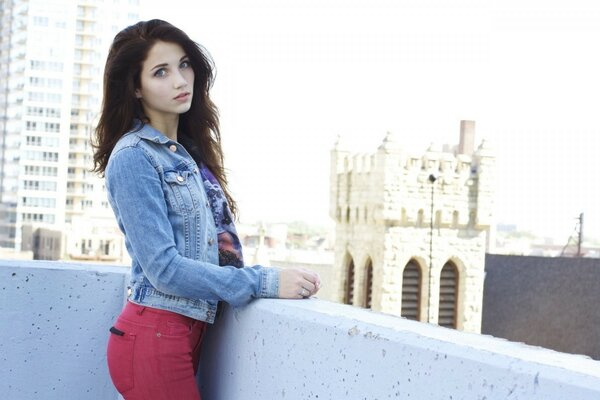 A young woman poses against the background of tasks