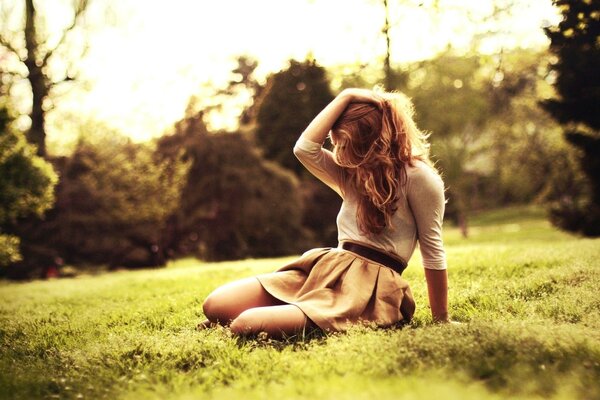 Mysterious girl in a skirt on the grass