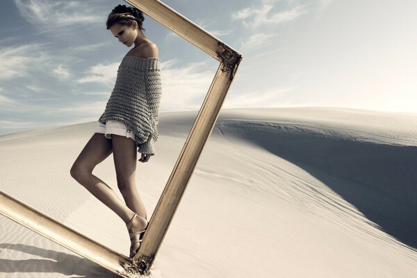 The girl in the frame. A model in the desert