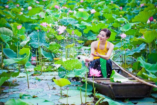 A girl in a boat among flowers