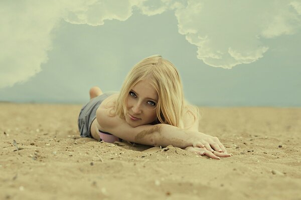 Cute girl lying on the beach