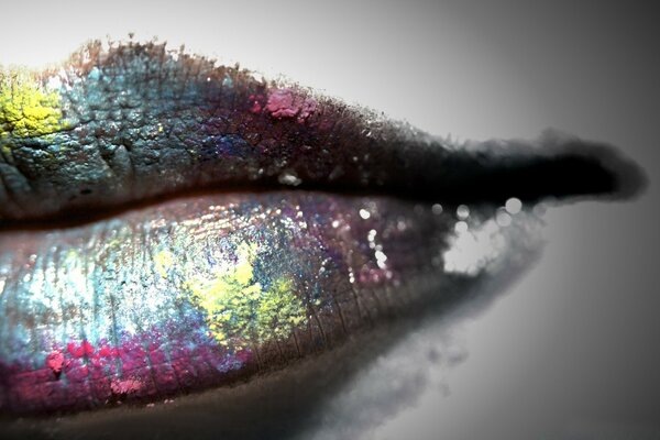 Bright multicolored lipstick on the lips