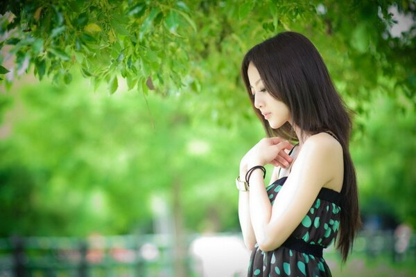 A girl in the summer in the park in nature