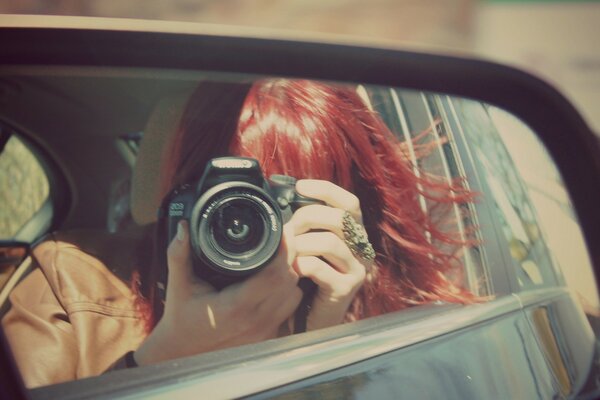 Selfie photo in the rearview mirror