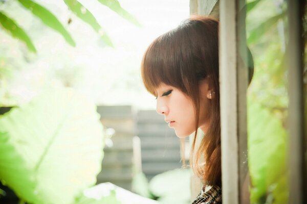 Portrait of a girl in summer on the balcony