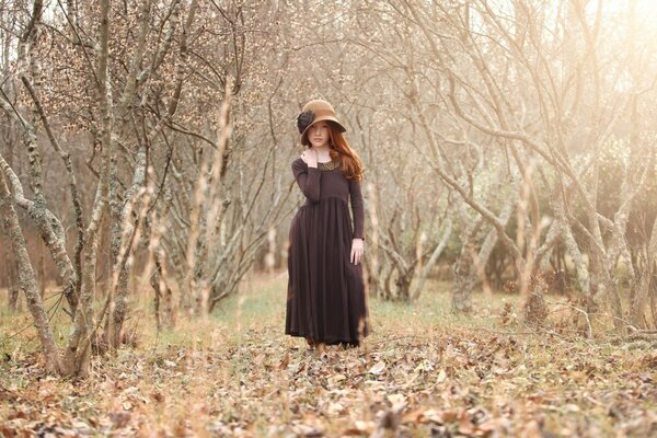 A girl in a bare autumn forest