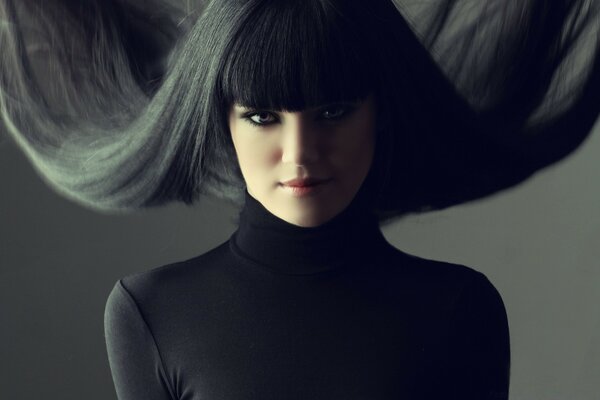 Portrait of a girl in a turtleneck with black hair