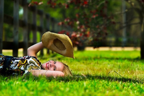 A girl with a hat in a summer park