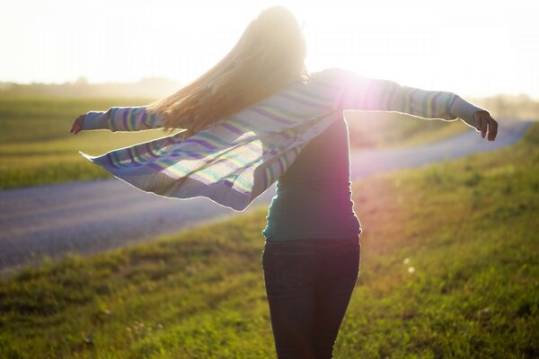 The girl is spinning in the rays of the sun