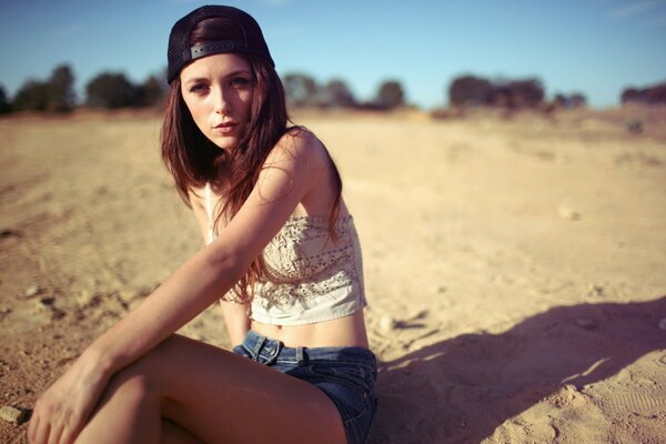 Beautiful girl on the sand in summer