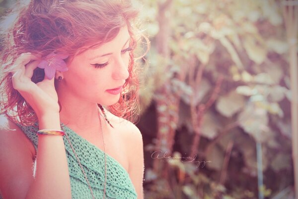 Red-haired girl with a flower in her hair