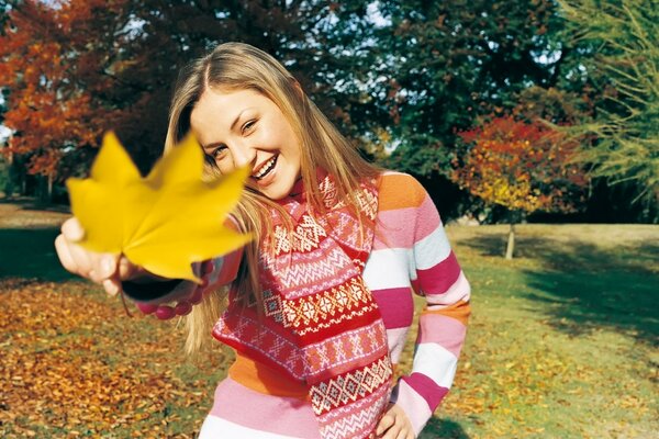 A girl giving a maple leaf