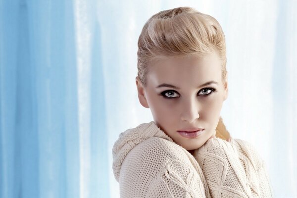 The exciting look of a blonde on a blue background