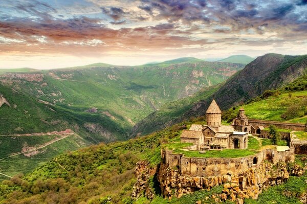 An ancient building on a green wasteland