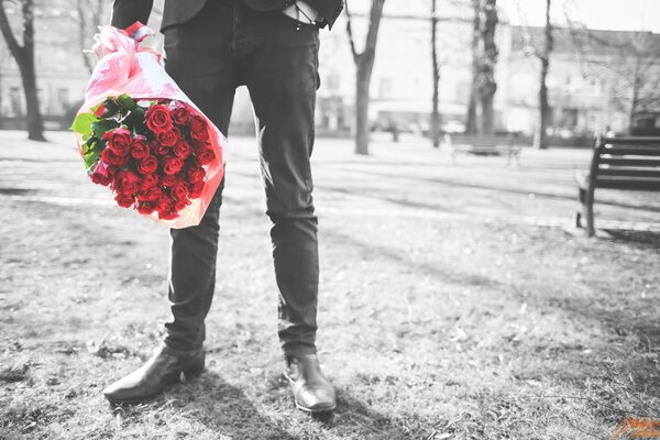 Man outdoors with a bouquet of flowers