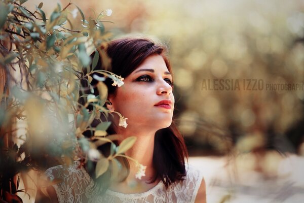 Retrato de una morena en la naturaleza con flores