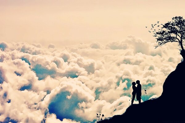 A couple in love on a mountain above the clouds