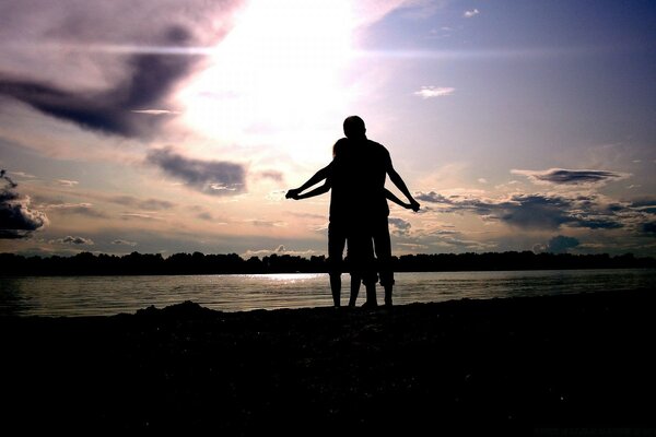 A young couple against a bright sky