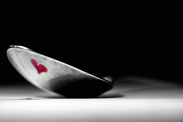 Heart on a spoon on a dark background