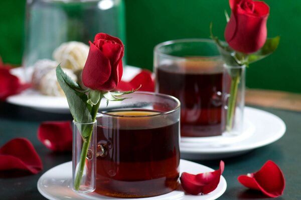 Two cups of tea decorated with roses on the table