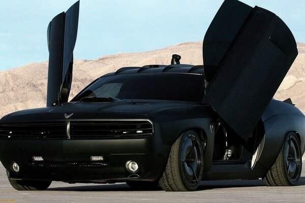 Cool black car with folding doors on a deserted road