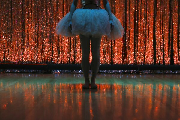 A girl in a tutu on the water. Music