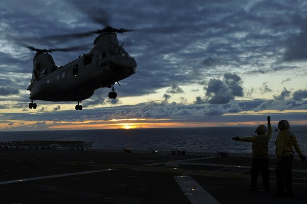 A military helicopter takes off from the airfield