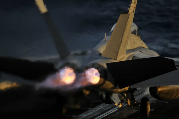 A turbine-powered fighter aircraft gaining speed