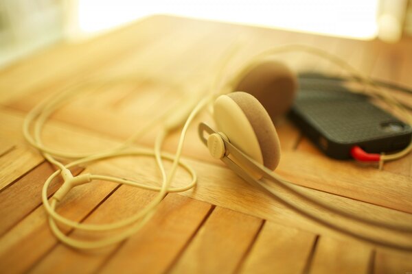 Smartphone with wired headphones on the table