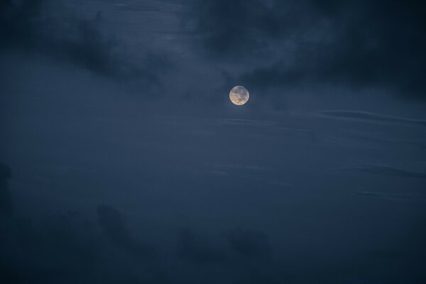 Foggy night sky moon in clouds