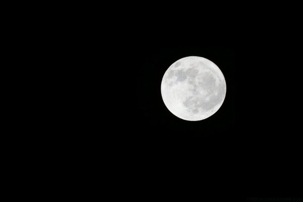 White and big Moon on black background